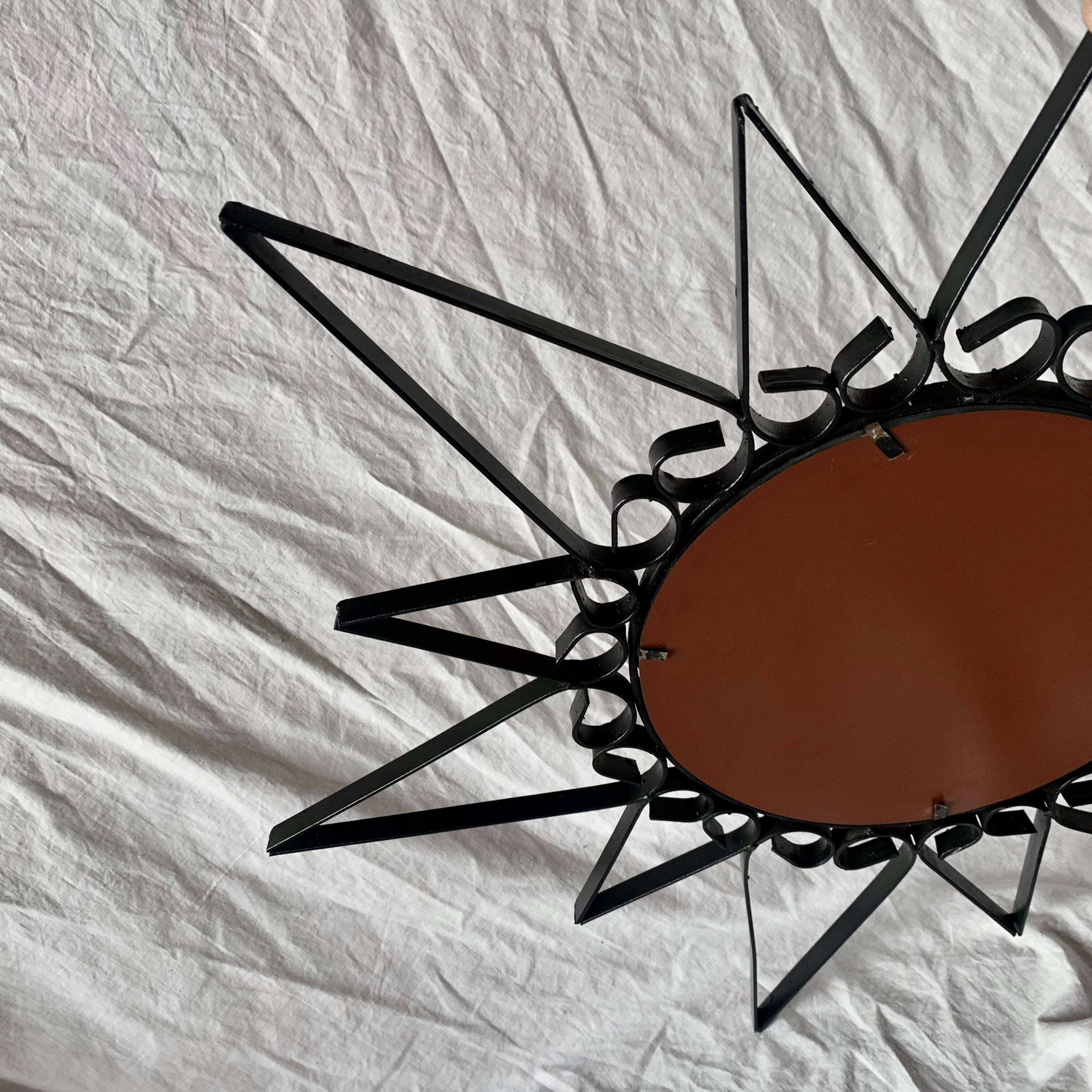 Old wrought metal sun mirror