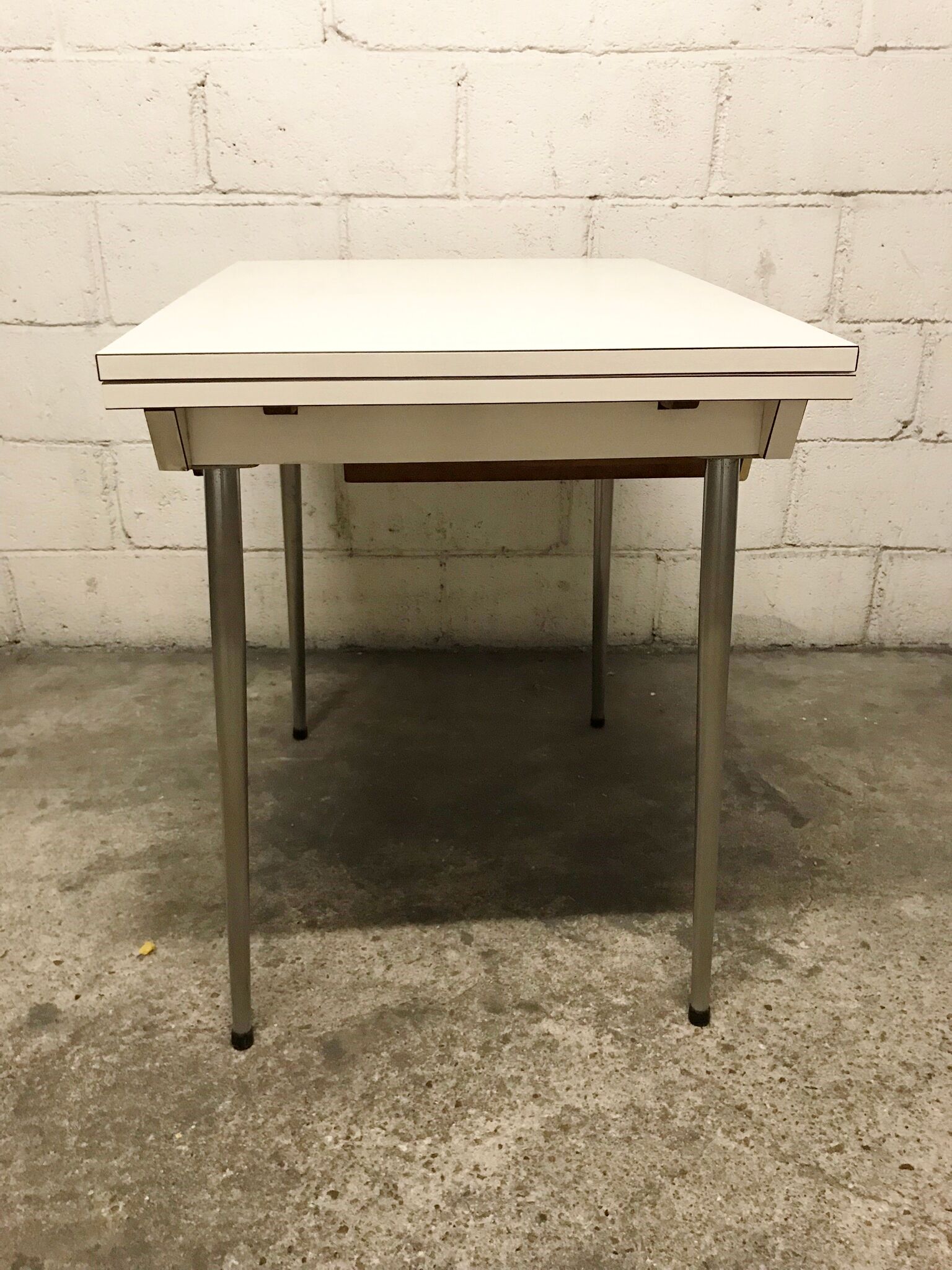 Off-white formica table / 70s cream with a tapered foot drawer