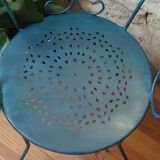 A pair of metal garden chairs