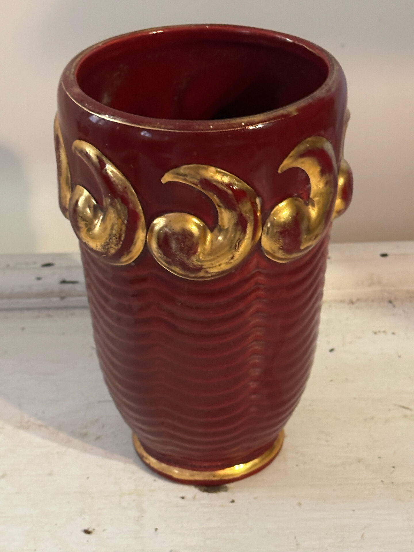 Mid-century relief vase in ruby red enhanced with gilding.