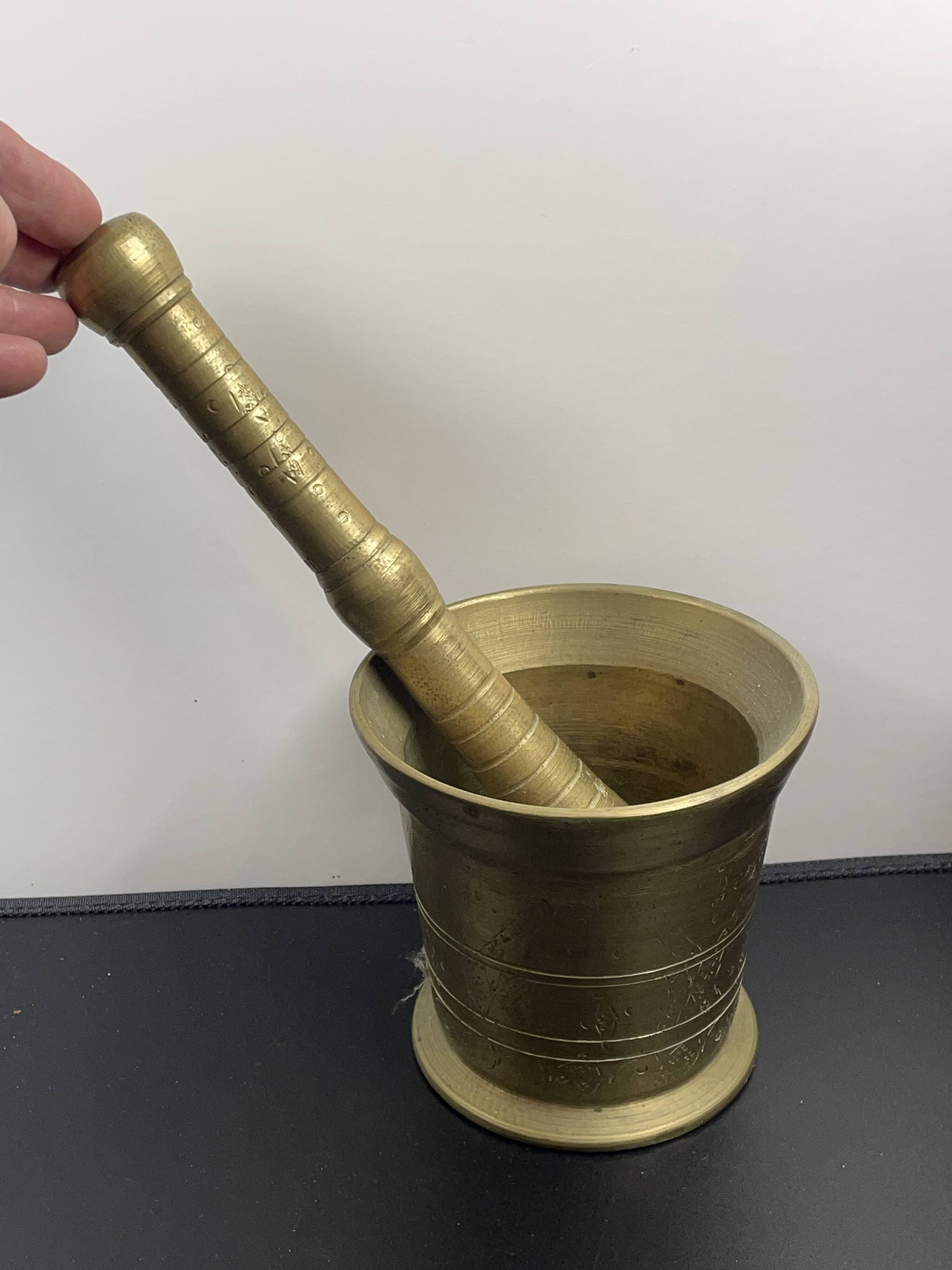Large mortar & pestle. Chiseled bronze or brass metal, scarified decoration