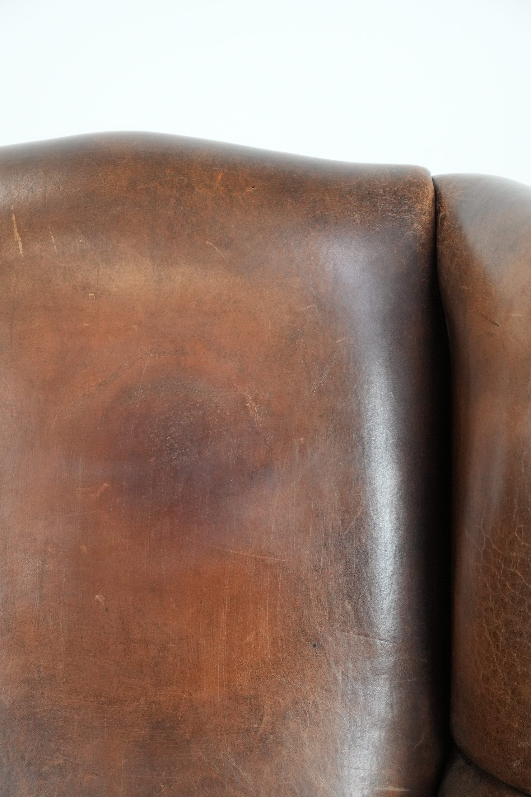 Vintage wingback armchair made of sheepskin leather with beautiful colours