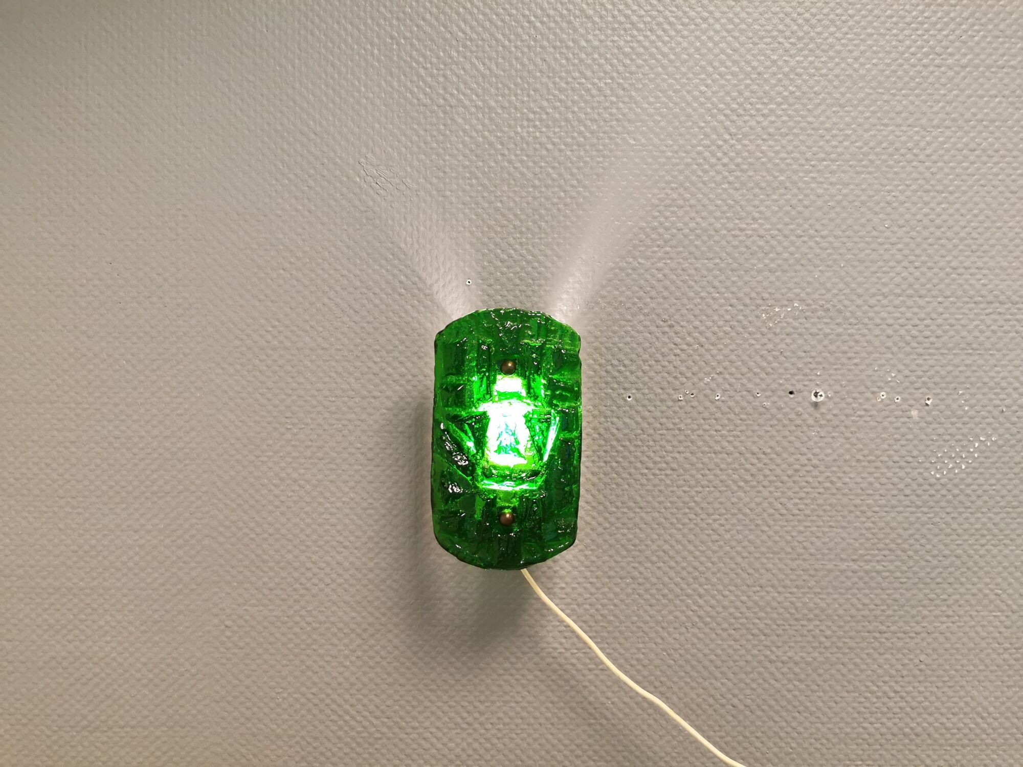 Old wall lamp made of hard pressed green glass.