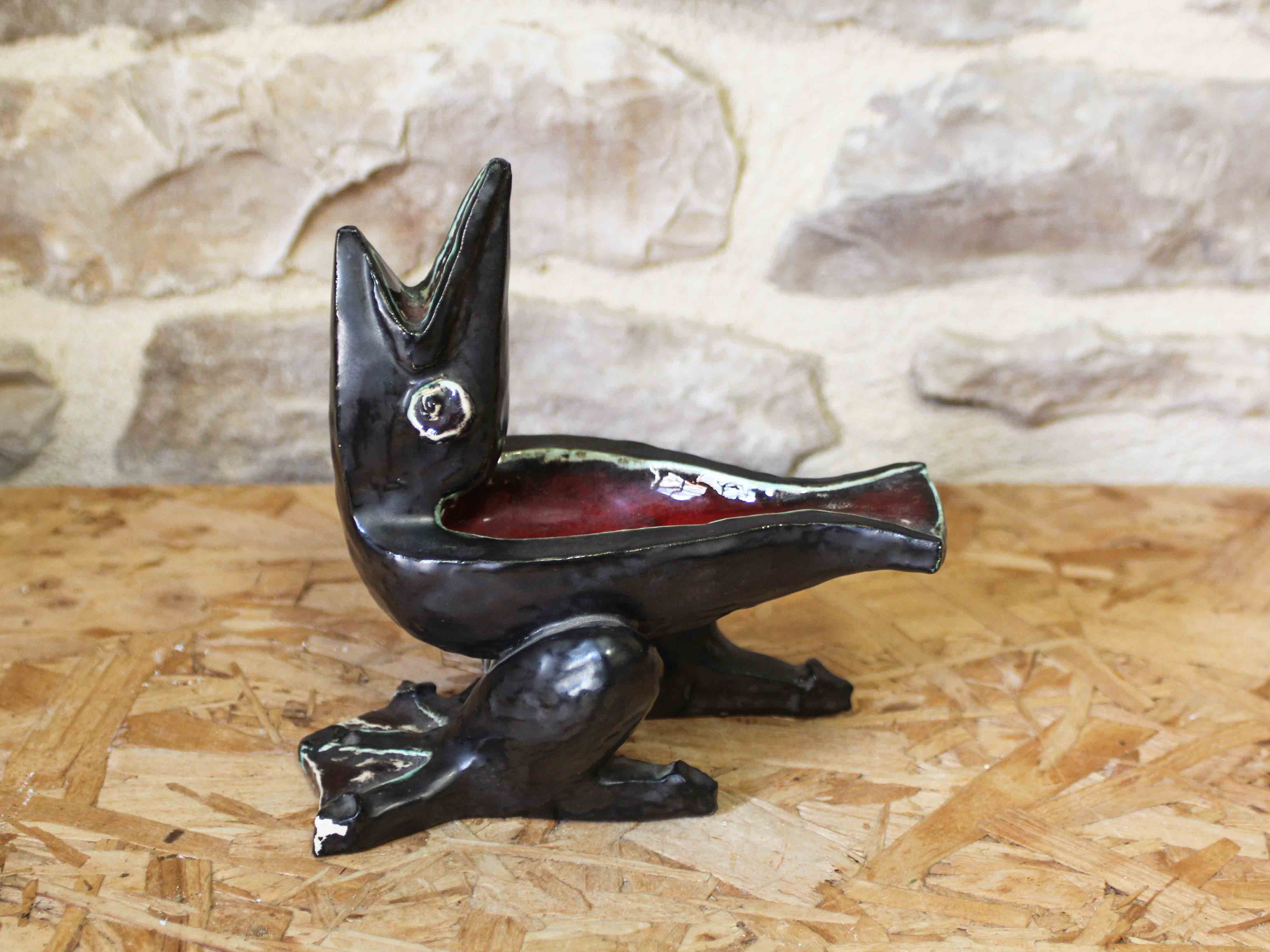 Glazed ceramic ashtray in the shape of a bird.