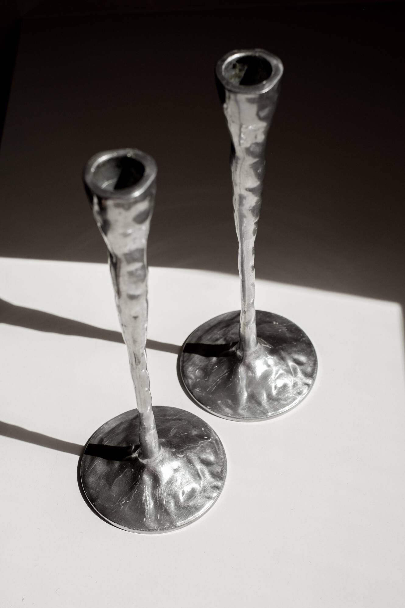 Pair of aluminium candle holders