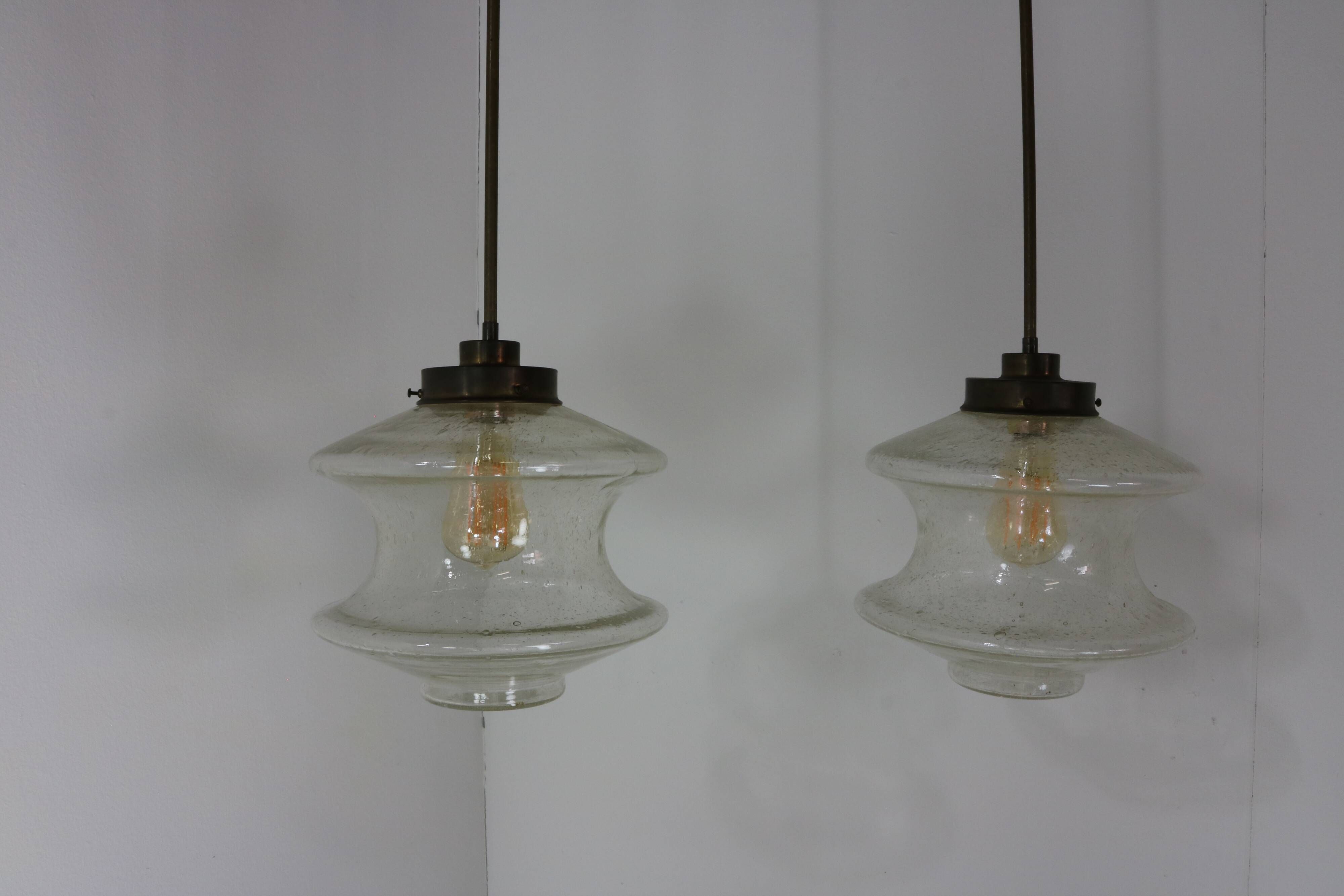 Set of two glass pendant lighting designed by Raak Holland