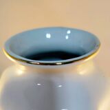 White ceramic vase with floral patterns