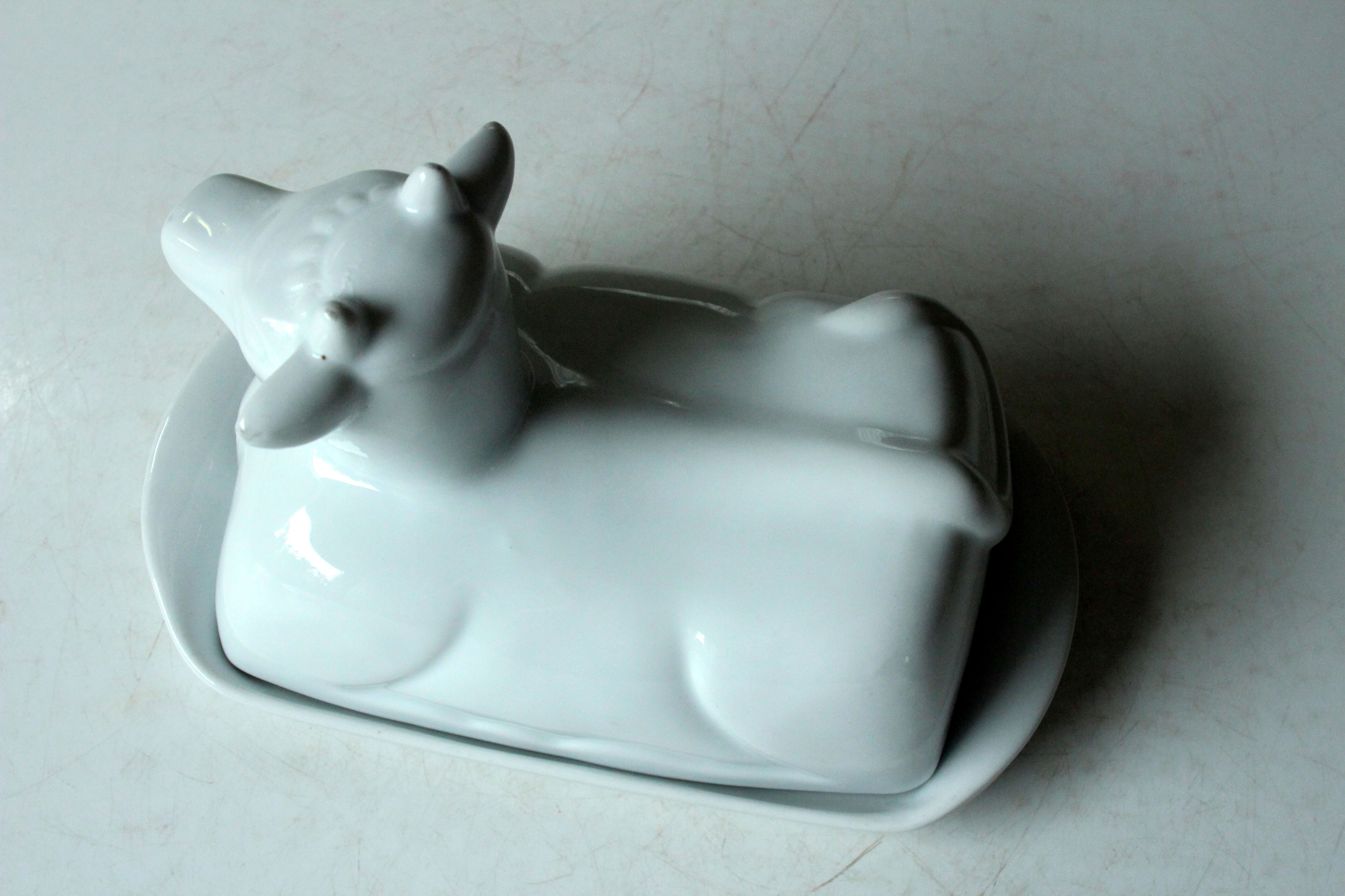 White ceramic butter dish in the shape of a cow, vintage