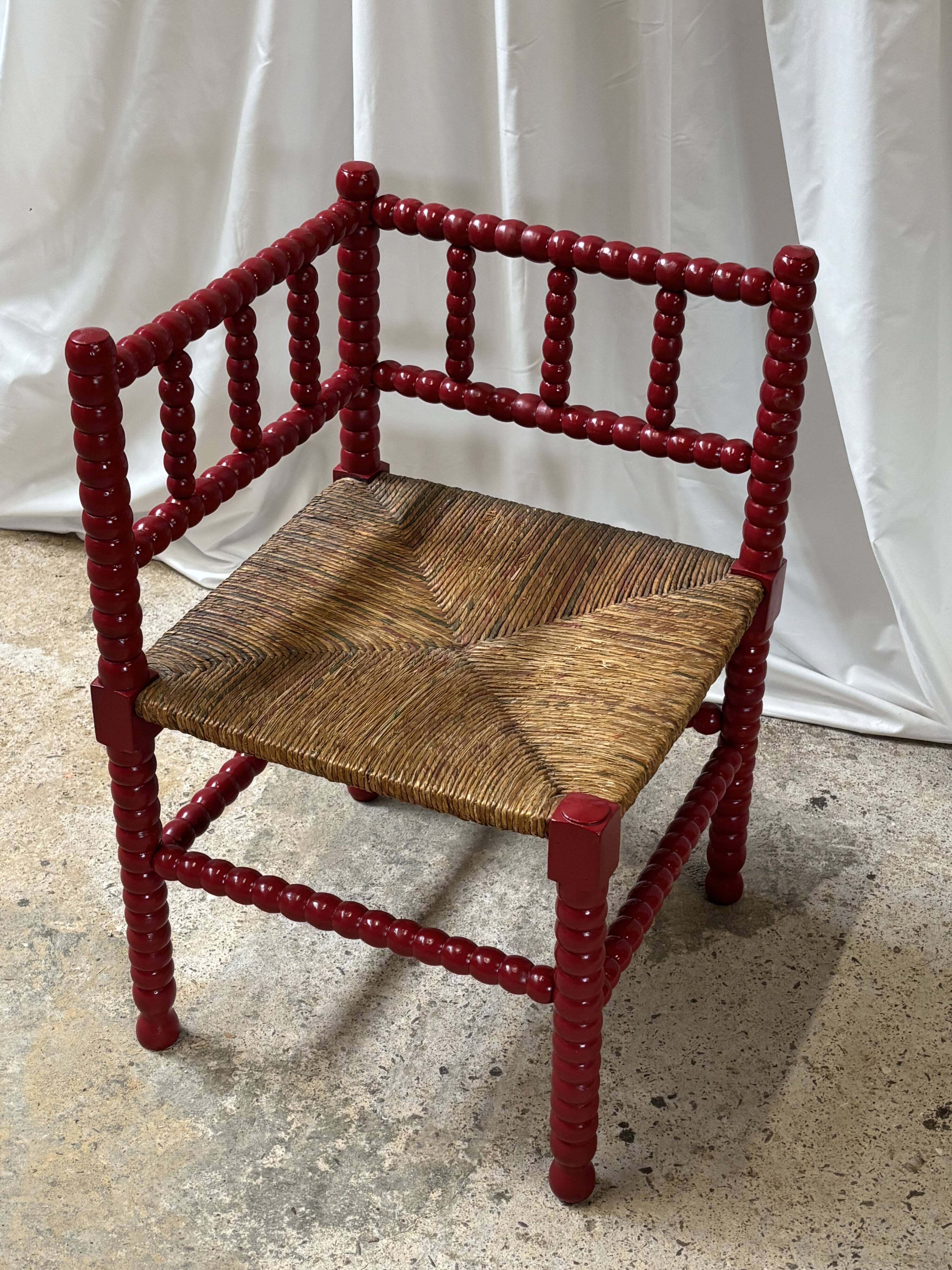 Red turned wood corner chair with rush seating