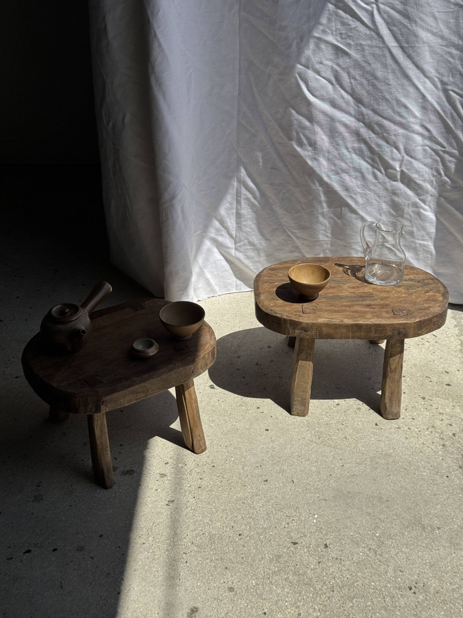 Small stool, oval solid teak side table with curved legs in wabi-sabi style.