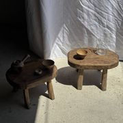 Small stool, oval solid teak side table with curved legs in wabi-sabi style.