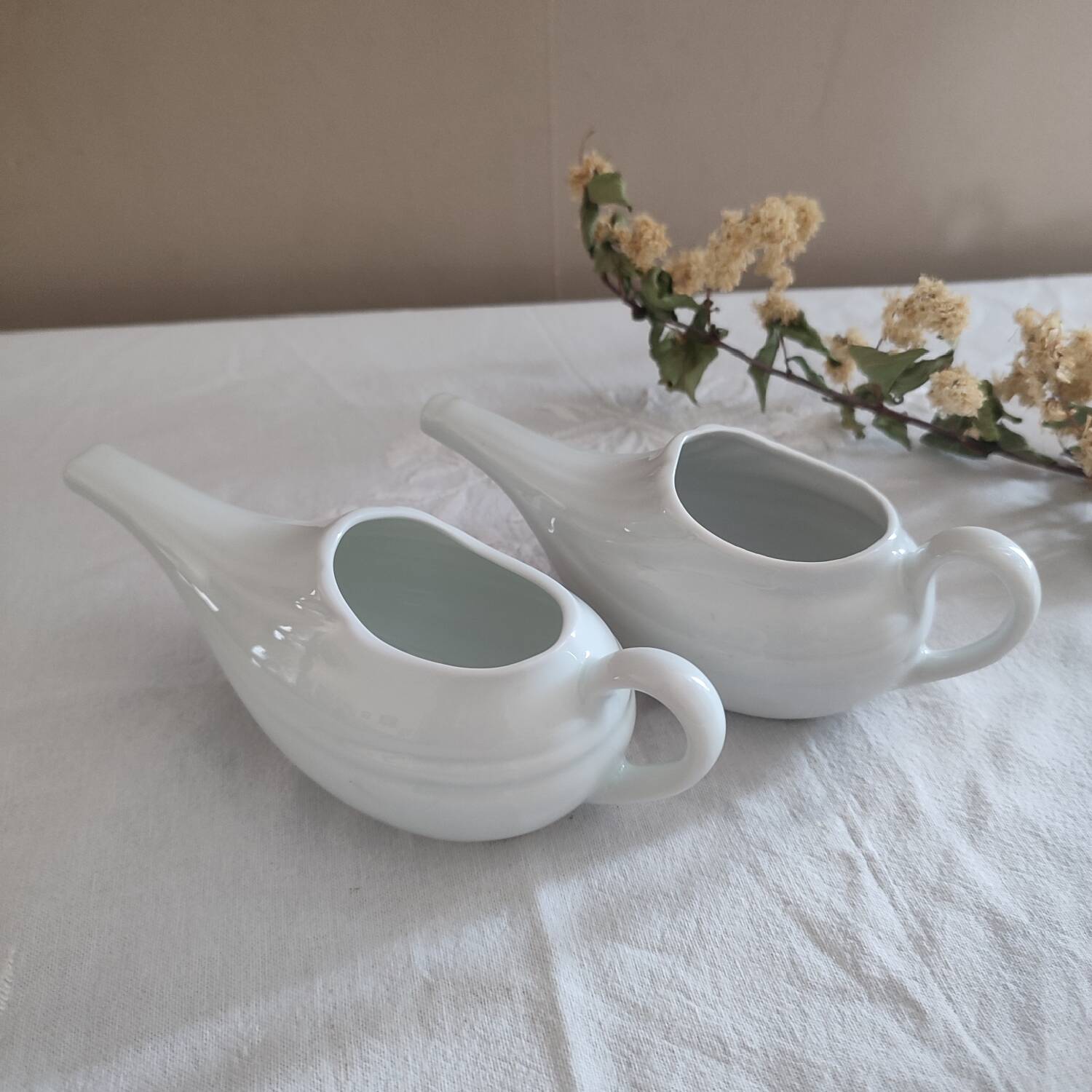 Duo of old white porcelain sauce boats for sick baby bottles