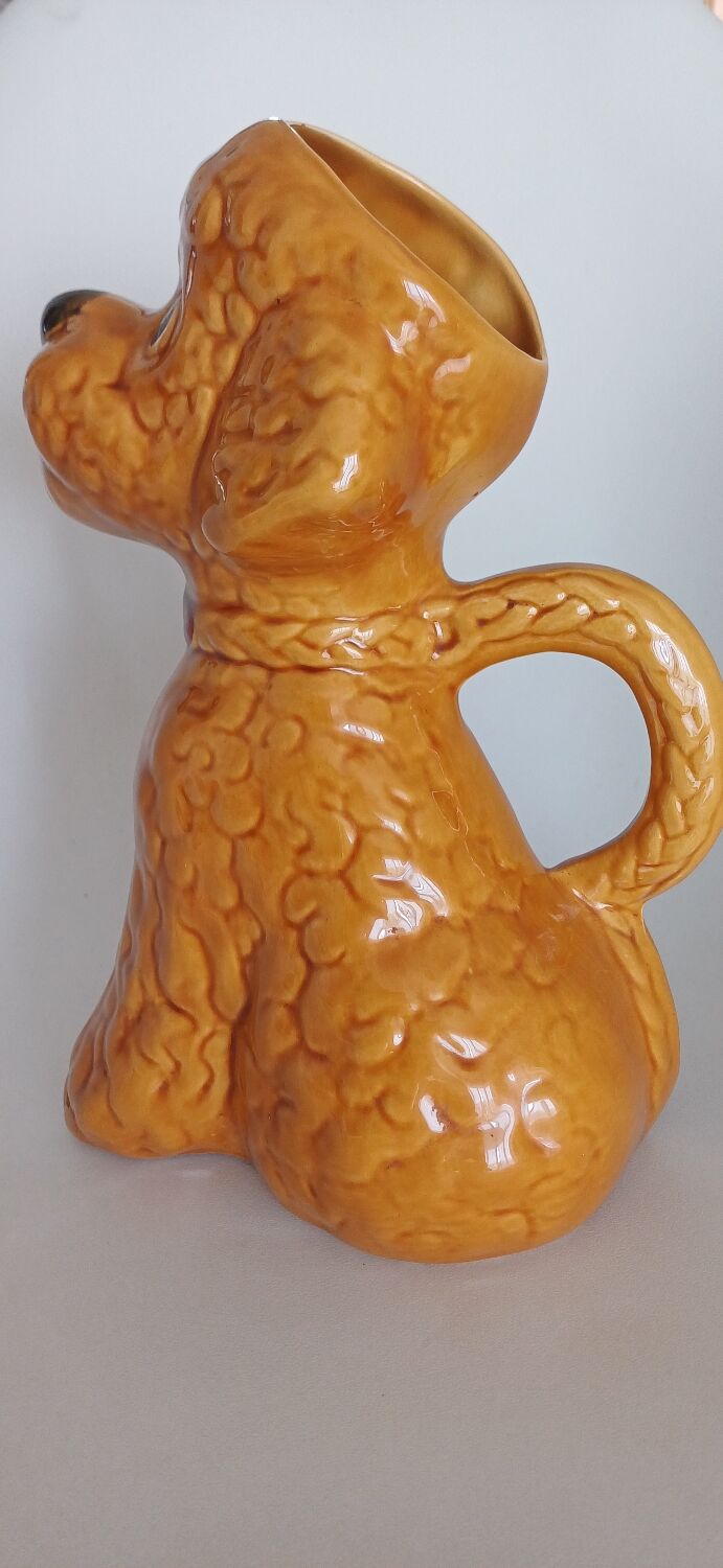 Ancient ceramic pitcher in the shape of a poodle.