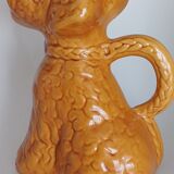 Ancient ceramic pitcher in the shape of a poodle.