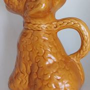Ancient ceramic pitcher in the shape of a poodle.