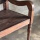 Small antique Indonesian bench in carved teak with plant and floral motifs.