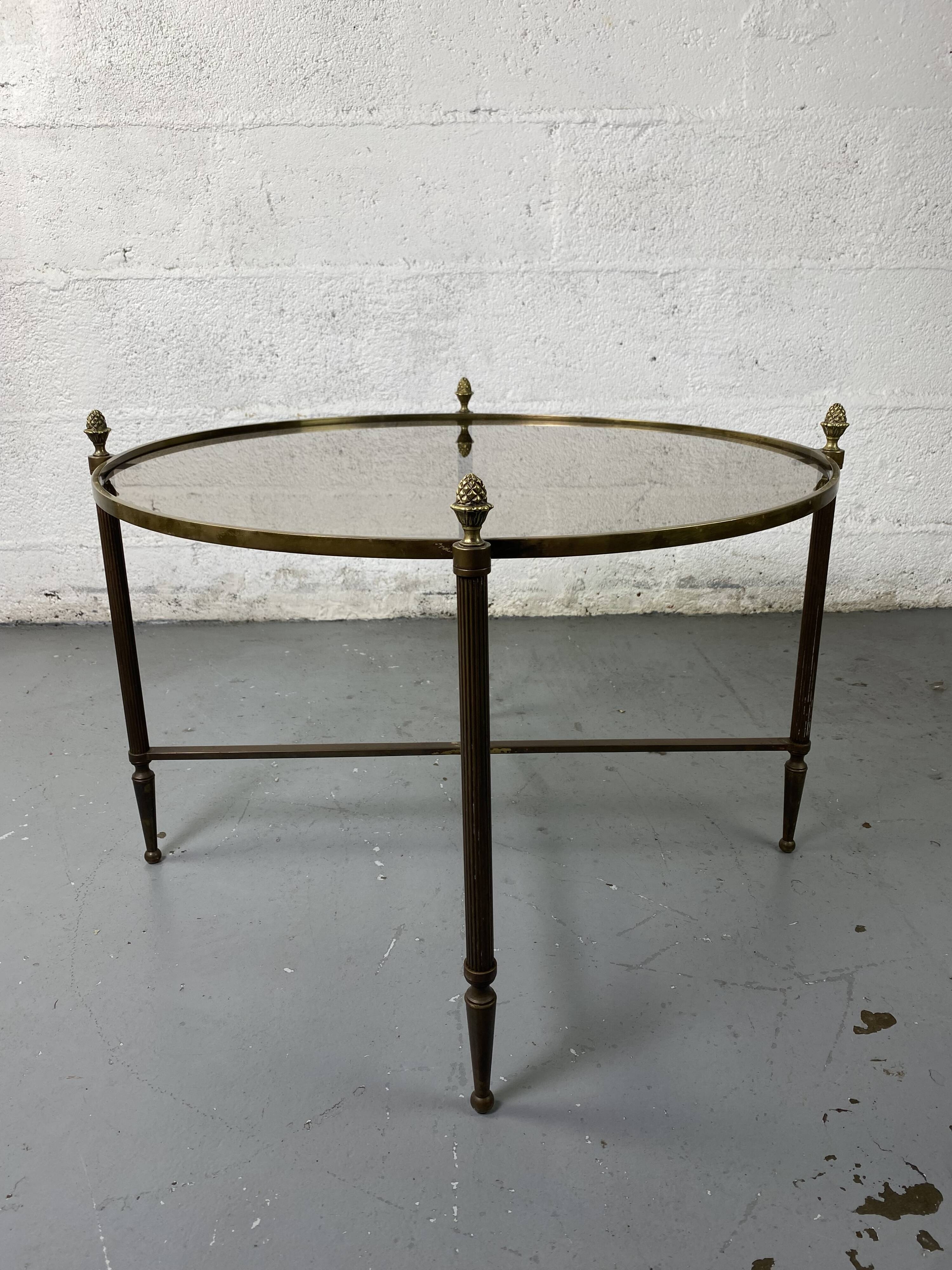 Round coffee table in brass and smoked glass