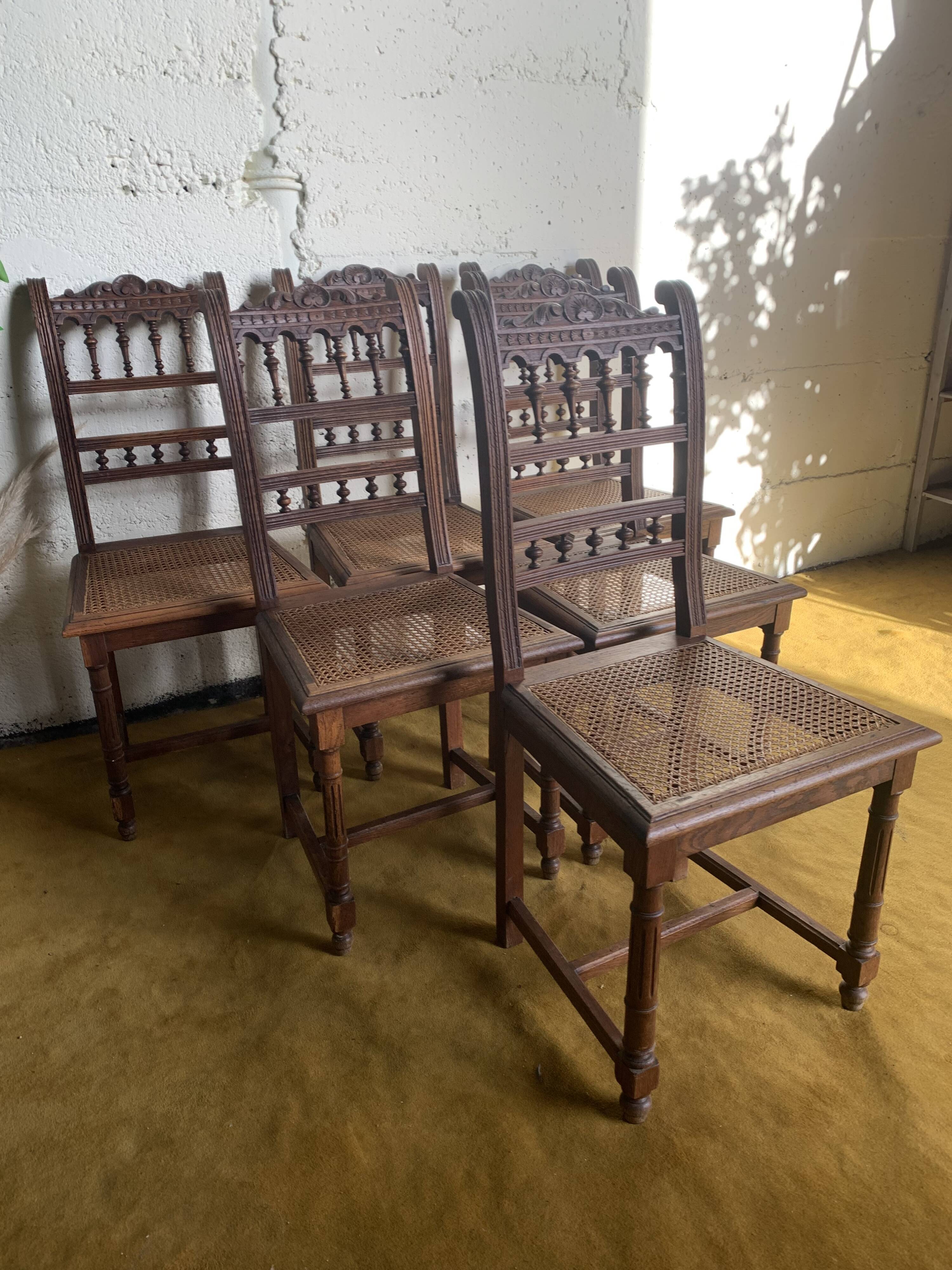 6 carved wooden chairs with cane seats