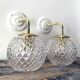 Set of two wall sconces in brass and glass