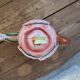 Ceramic teapot in the shape of a rose with a butterfly and raised petals.