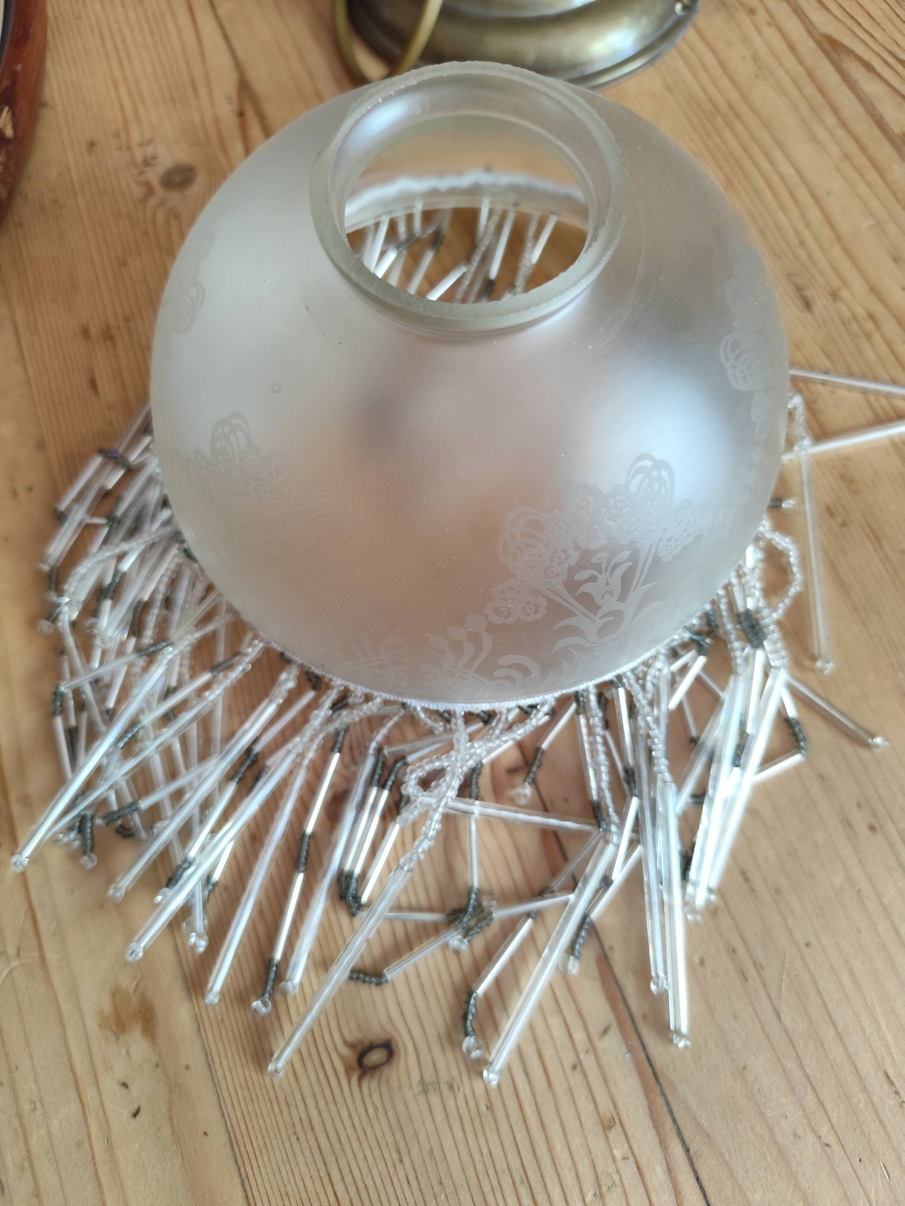 Retro brass lamp with a glass shade and bead fringes.