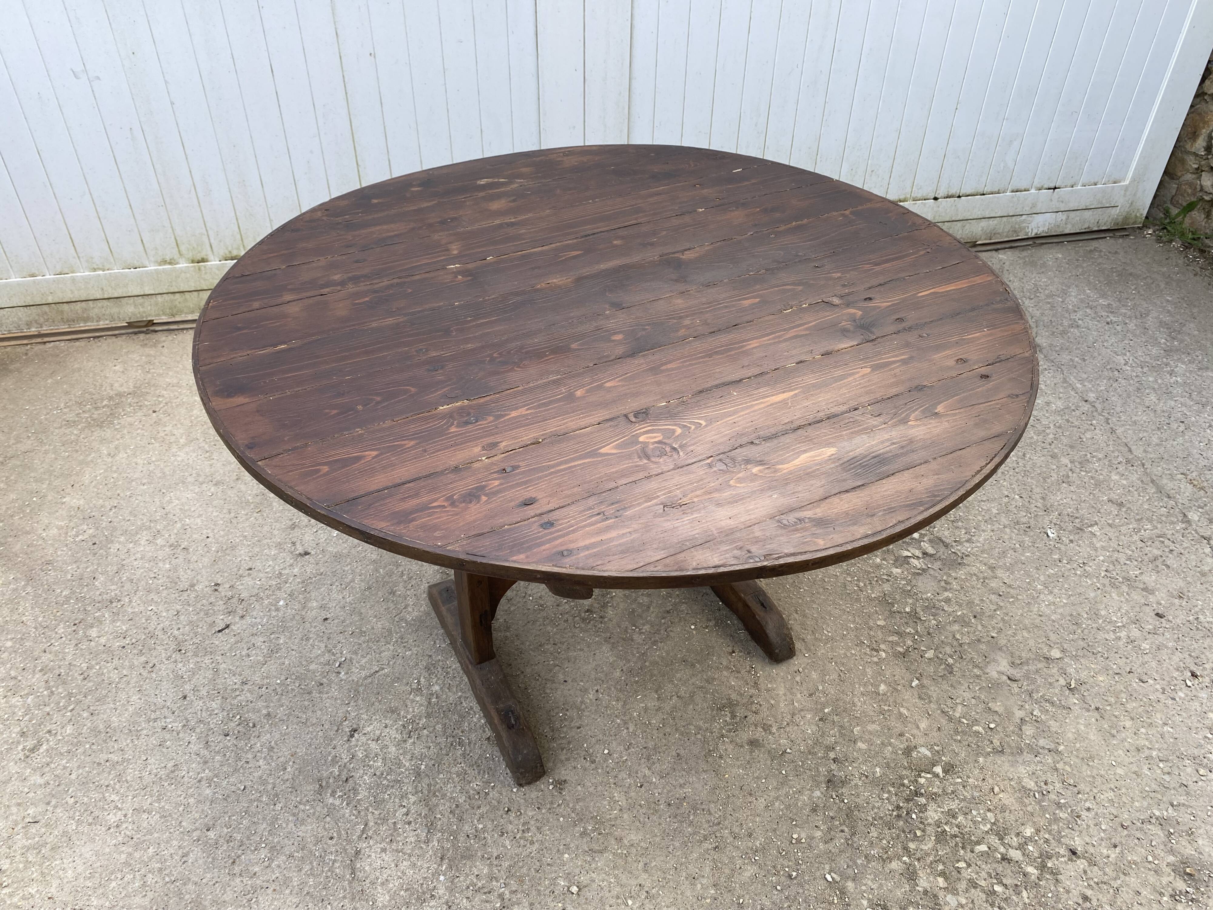 Old folding round winemaker's table with a tilting top.