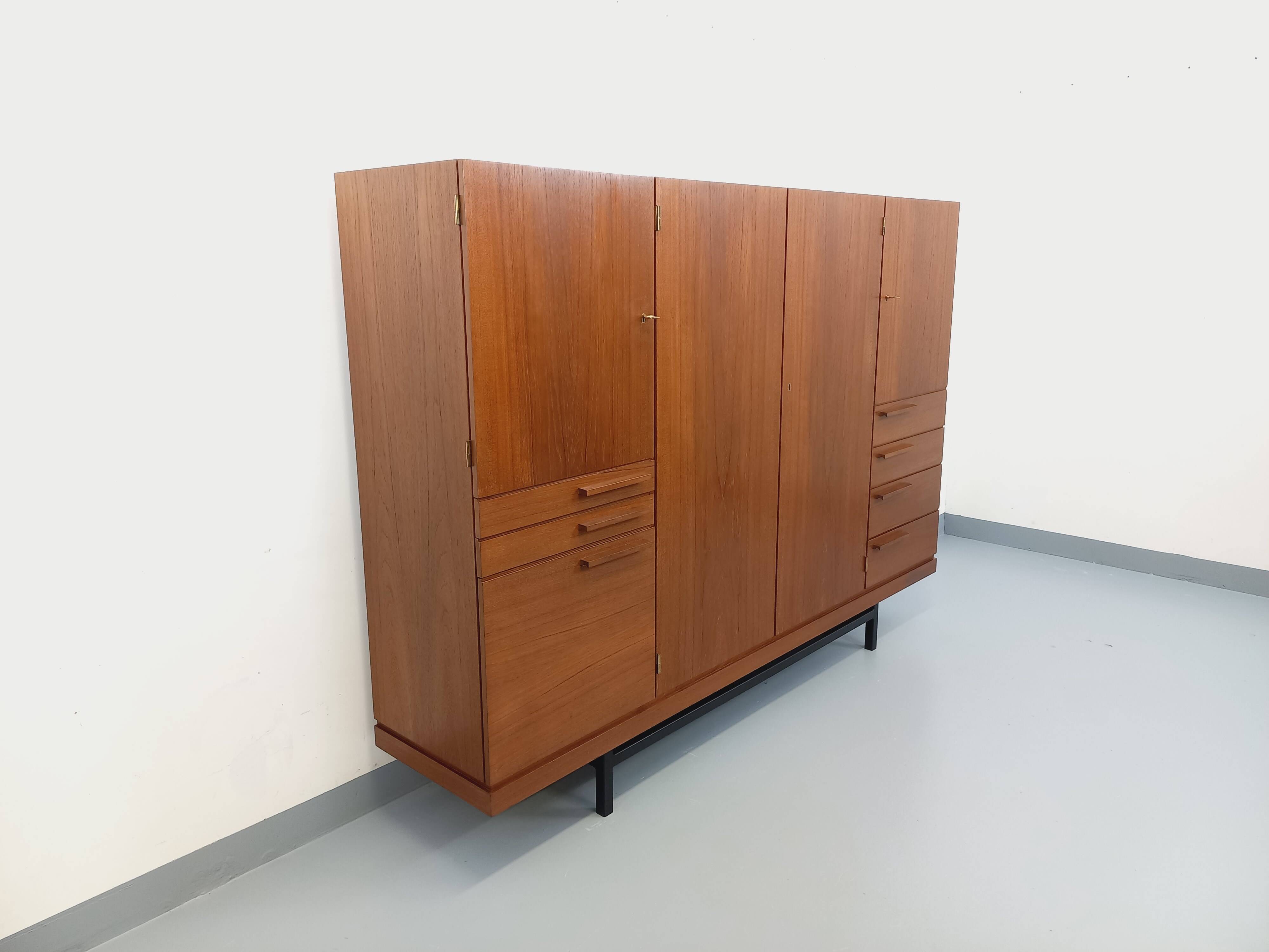 High Scandinavian modernist vintage sideboard in teak and black metal.