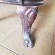 Old compact wood stove in enamelled cast iron with tripod feet with Lion's legs