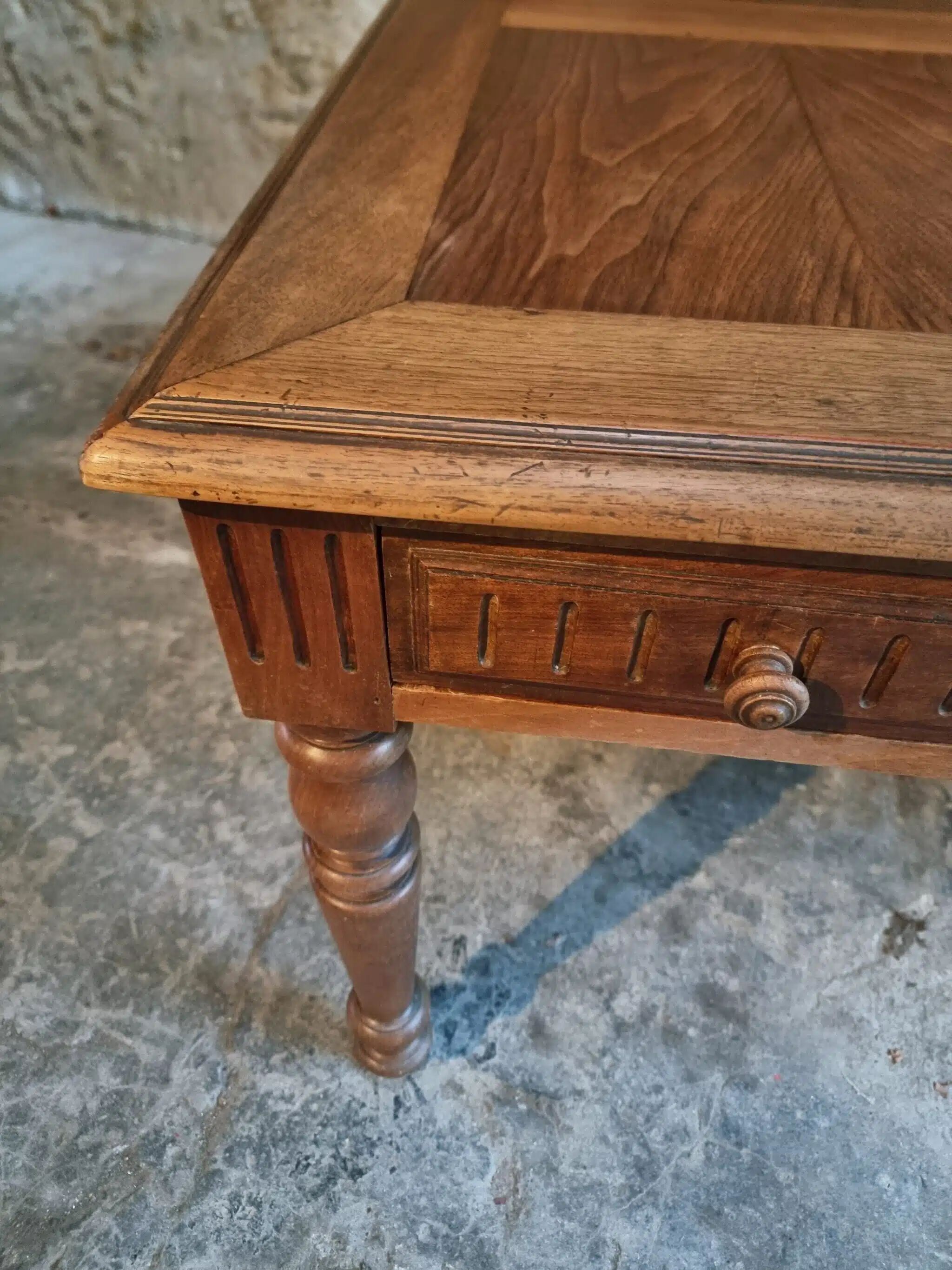 Antique French walnut table with six drawers, parquet top, early 20th century.