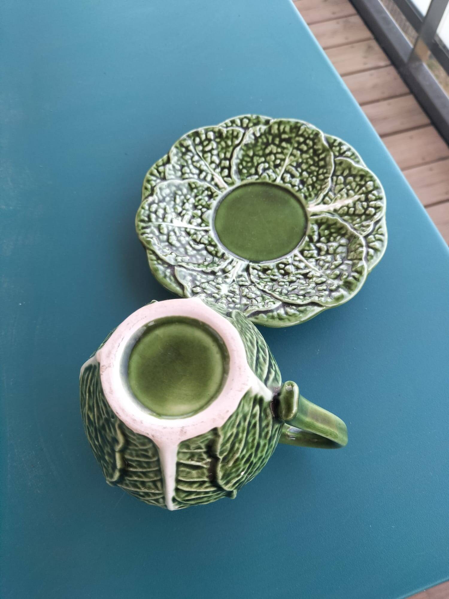 Vintage milk jug with cabbage leaf design in majolica with saucer.