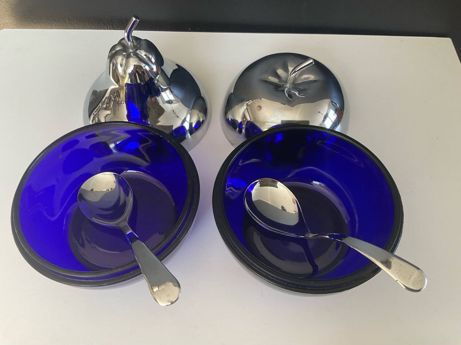 A pair of vintage cobalt glass and silver-plated sugar bowls.