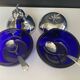 A pair of vintage cobalt glass and silver-plated sugar bowls.