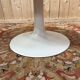 Round dining table with tulip base, 1960s design.