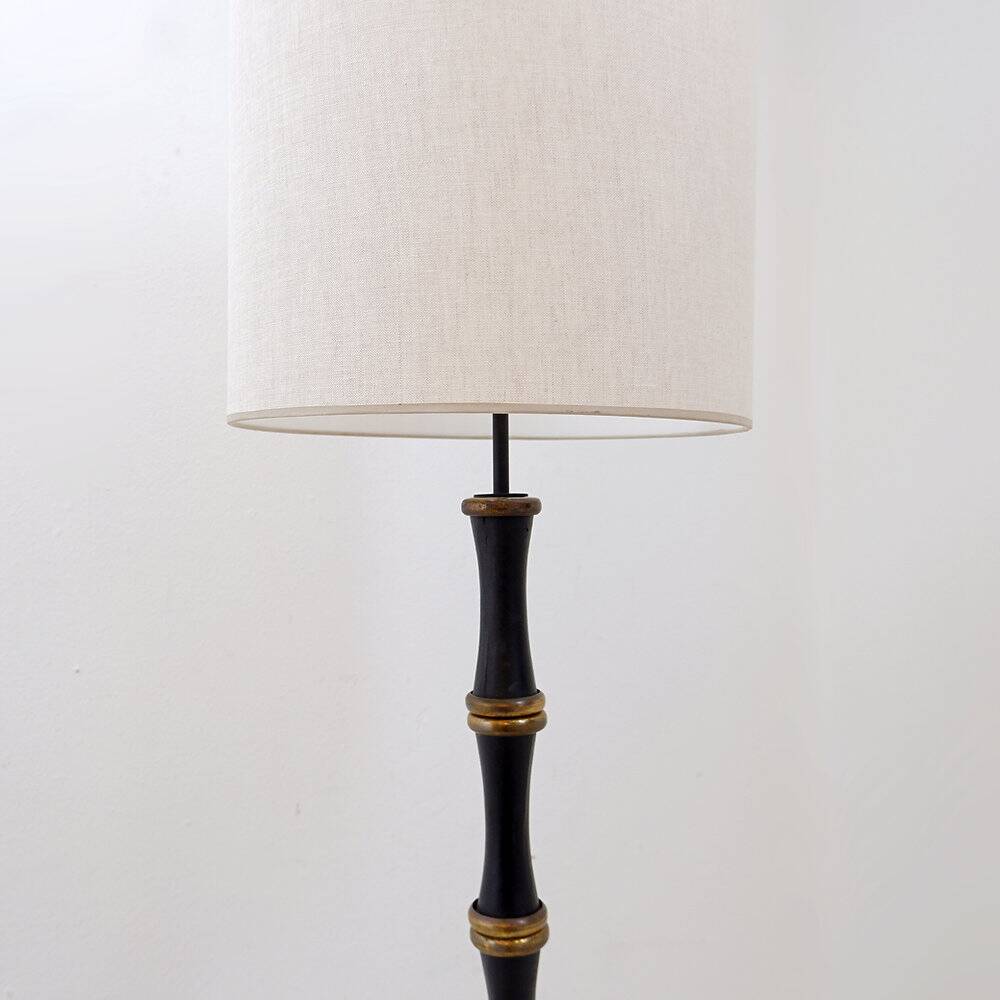 Tripod floor lamp in wrought iron and brass with bamboo-style base.