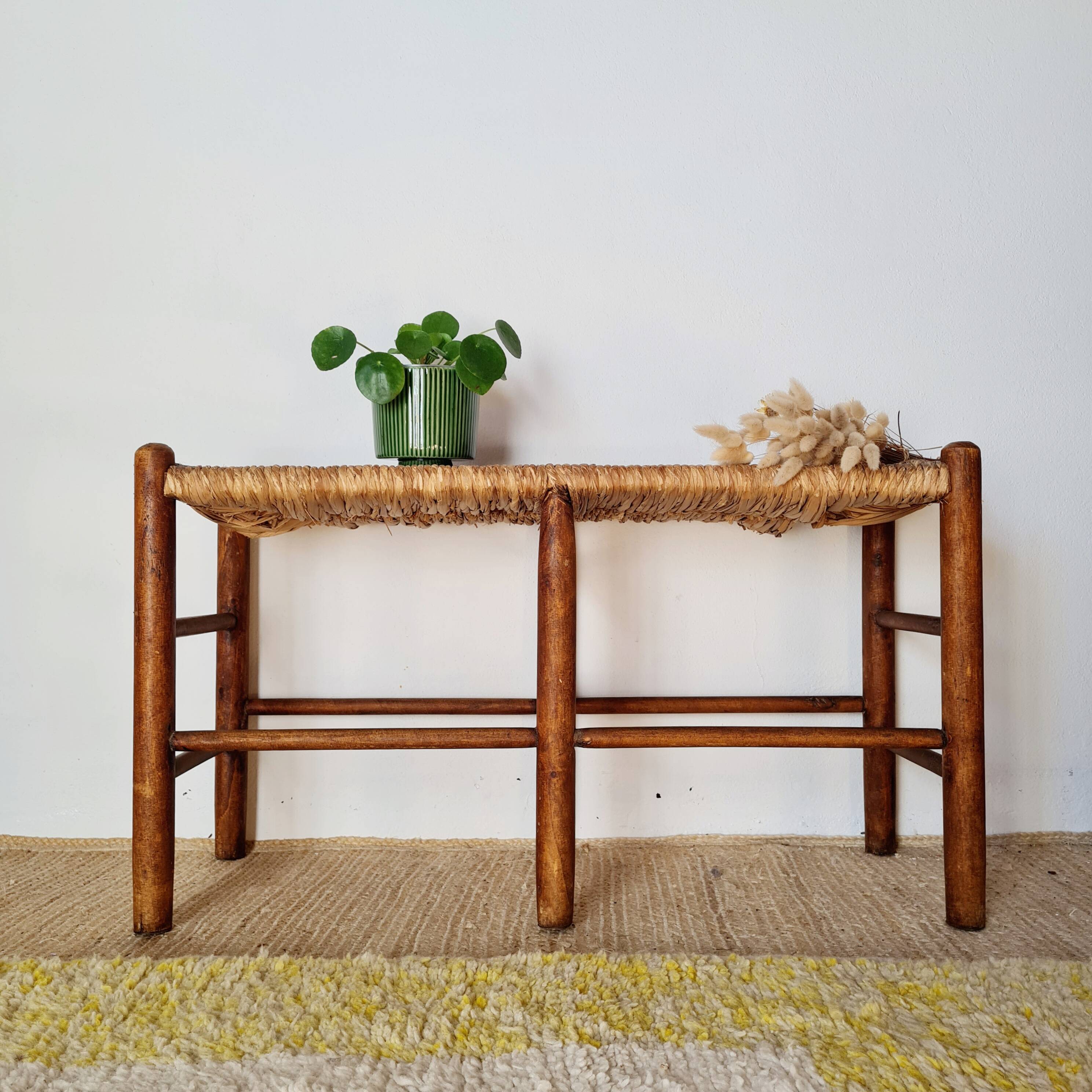 Old wooden and straw bench