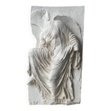 Ancient plaster bas-relief of Nike fastening her sandal.