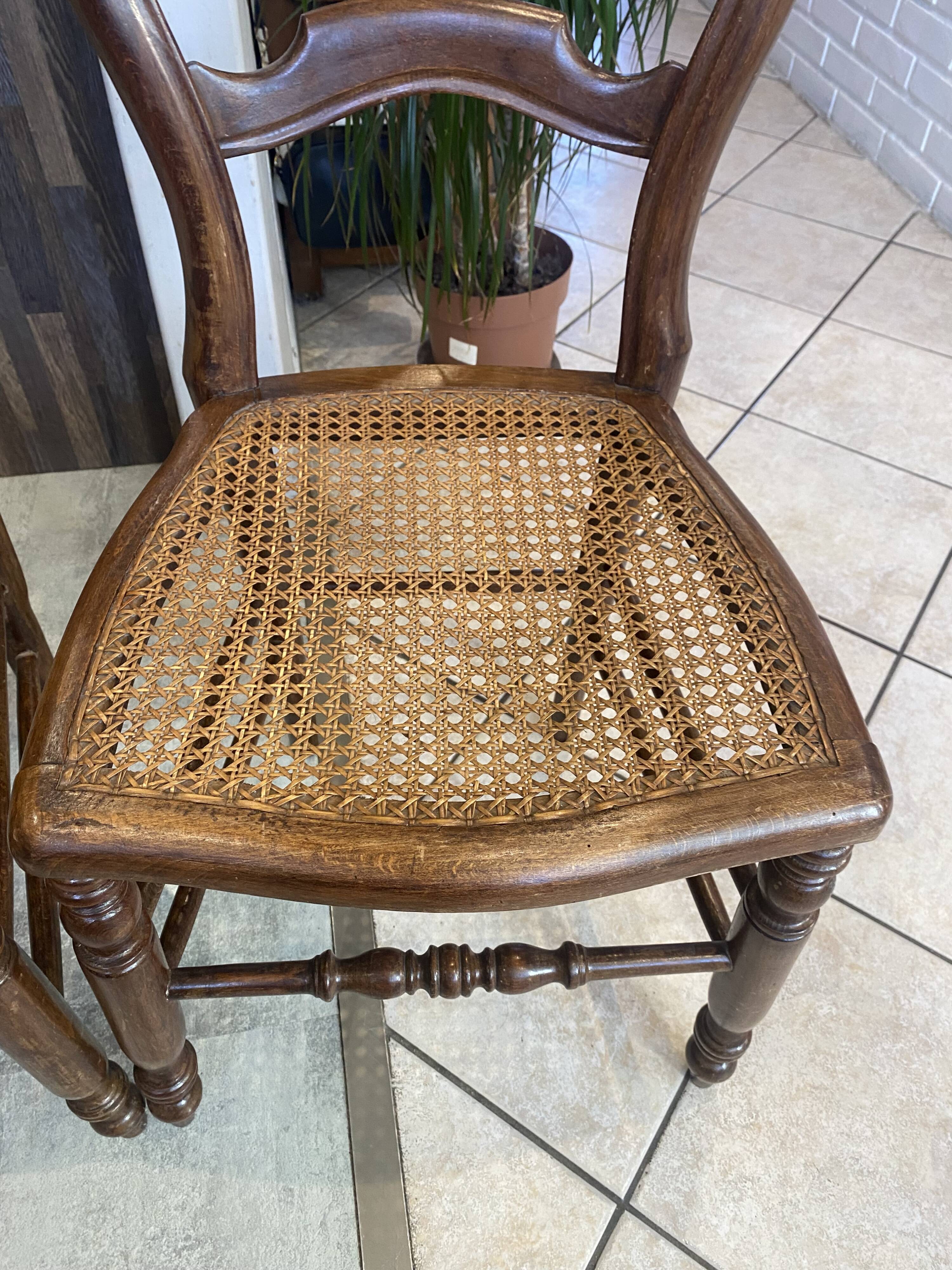 Pair of N2 antique caned and wooden chairs from the 1900s.
