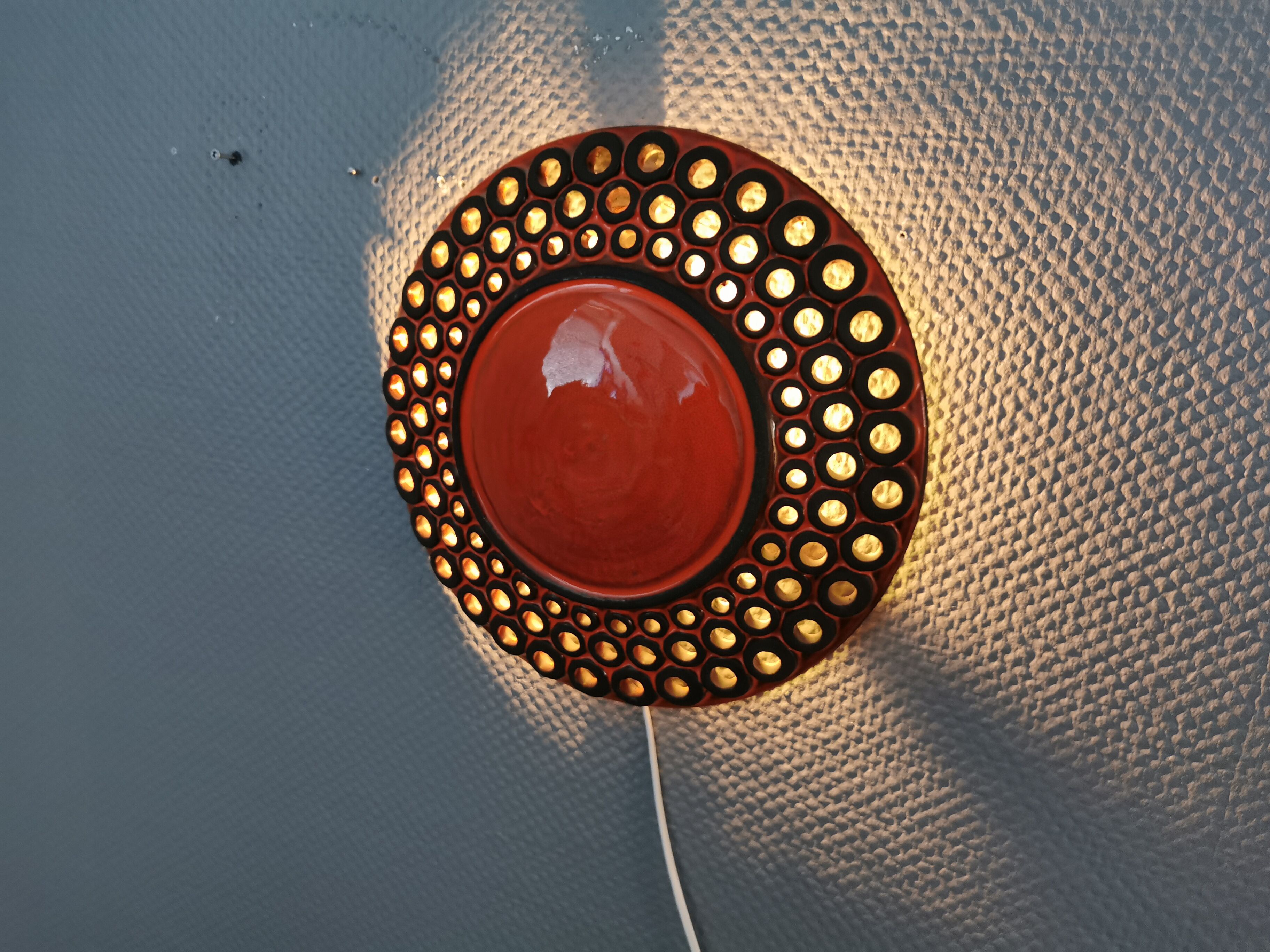 Wall light made from brown and red ceramic. Signed Norman Motala Sweden 1970s.