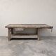 Antique wooden workbench with a vice and drawer.