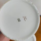 Vintage porcelain pickle pot with wooden pliers.