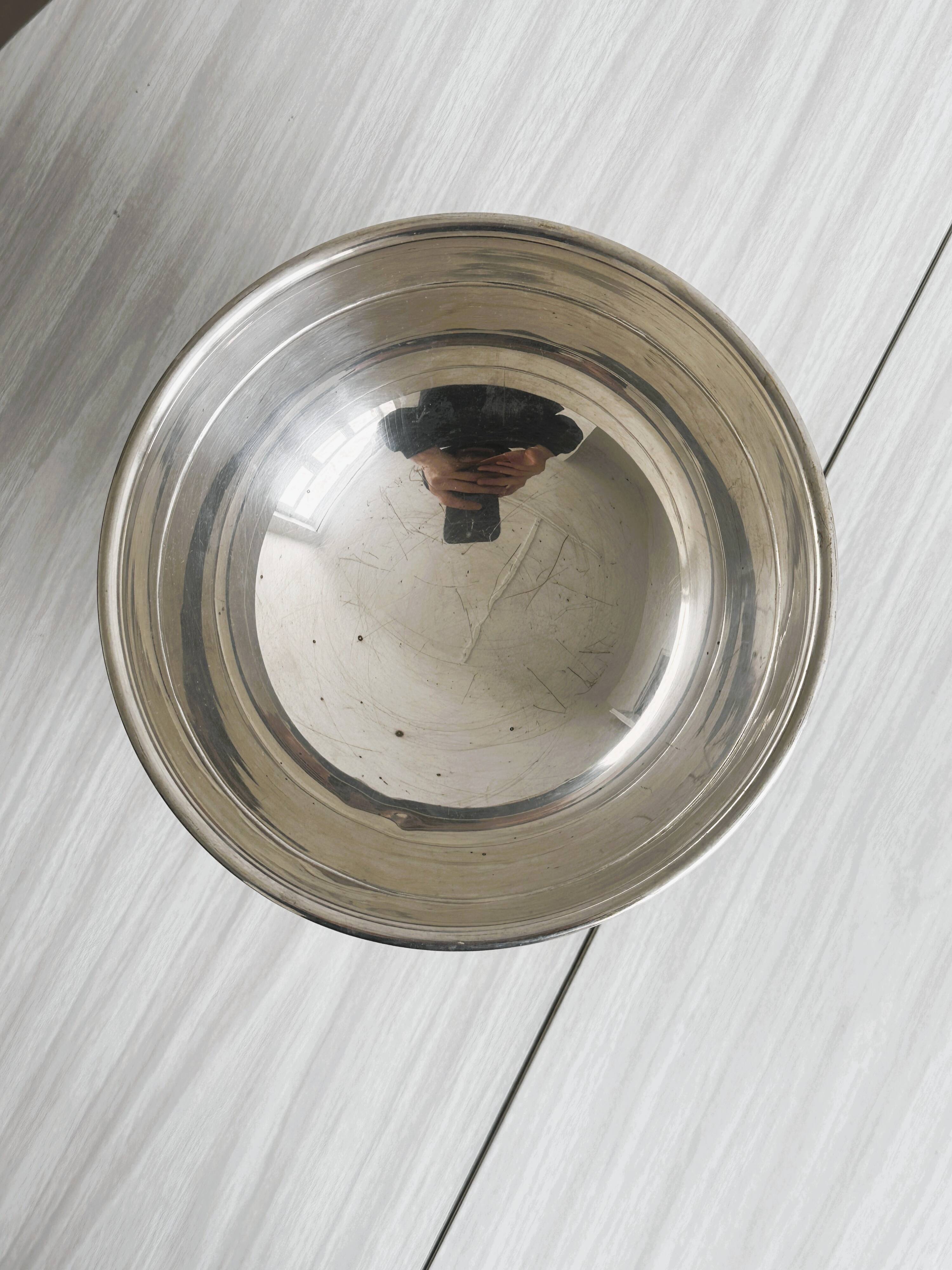 shiny silver metal cup on foot
