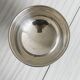 shiny silver metal cup on foot