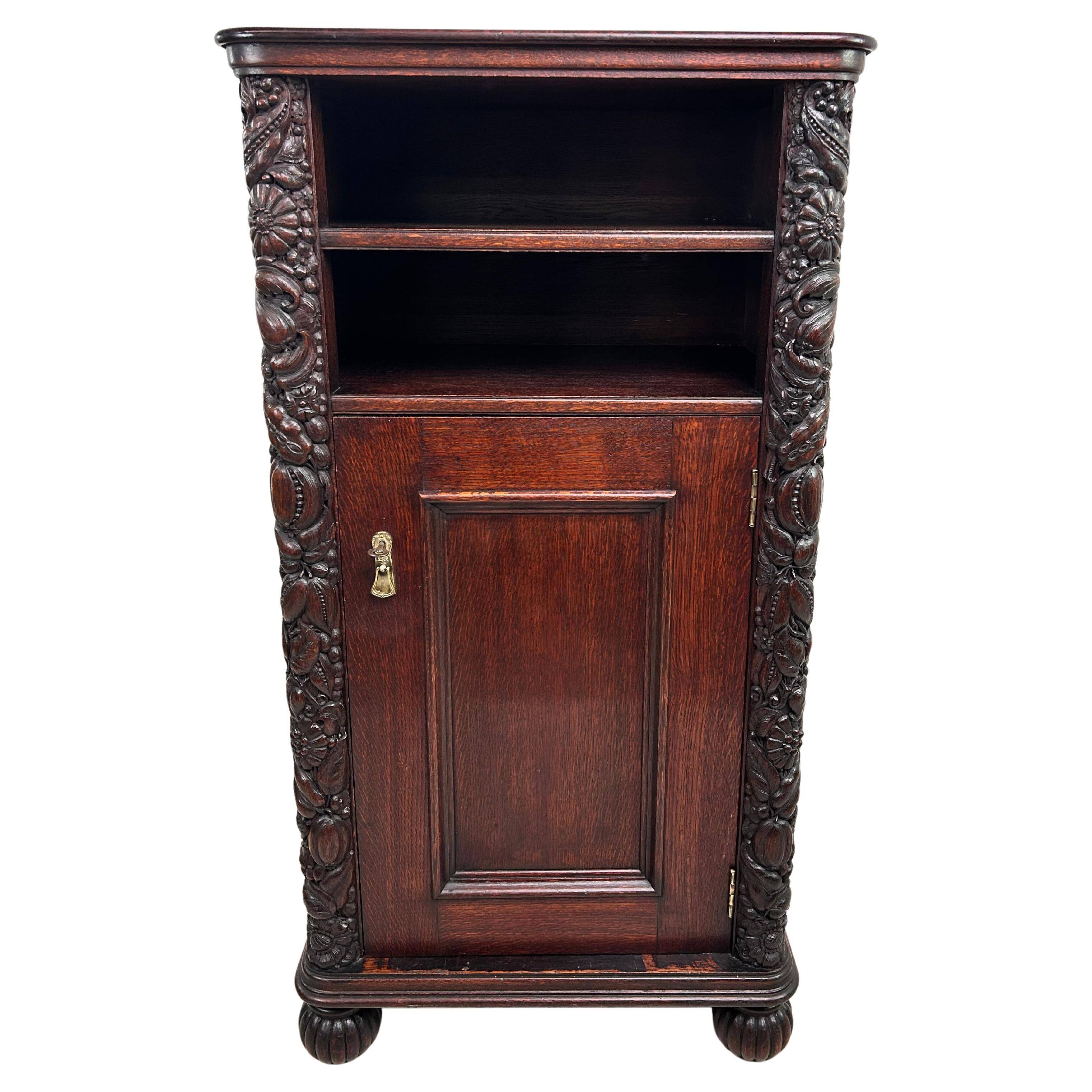 Art Nouveau cabinet with a shelf featuring distinctive floral sculptures.