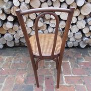 Curved wooden bistro chair with caning