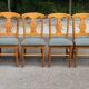 4 Landes chairs with solid wood frames and grey fabric.