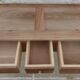 Console in solid walnut with a natural finish, featuring three drawers with a belt.