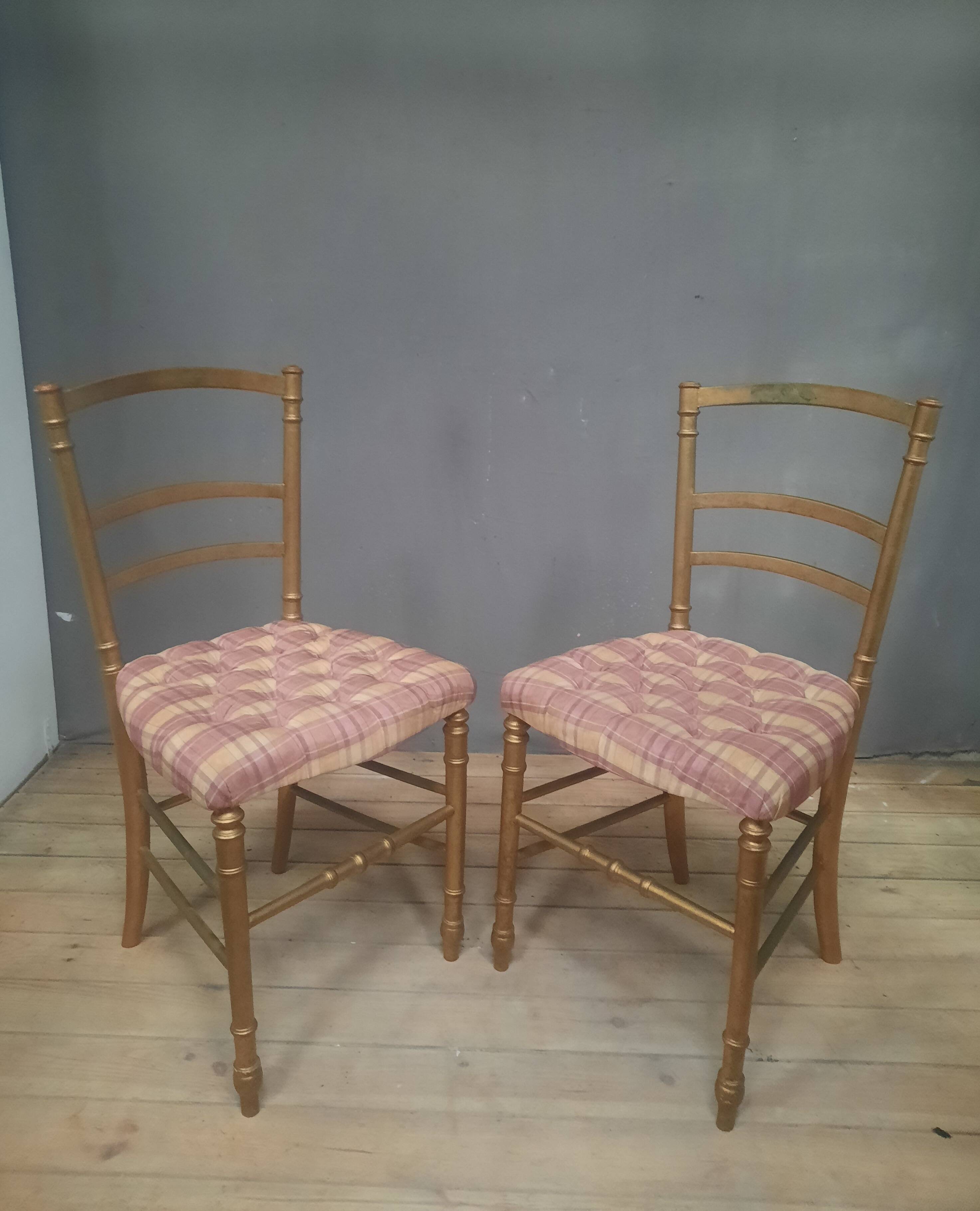 Pair of upholstered chairs in gilded wood