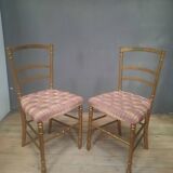 Pair of upholstered chairs in gilded wood