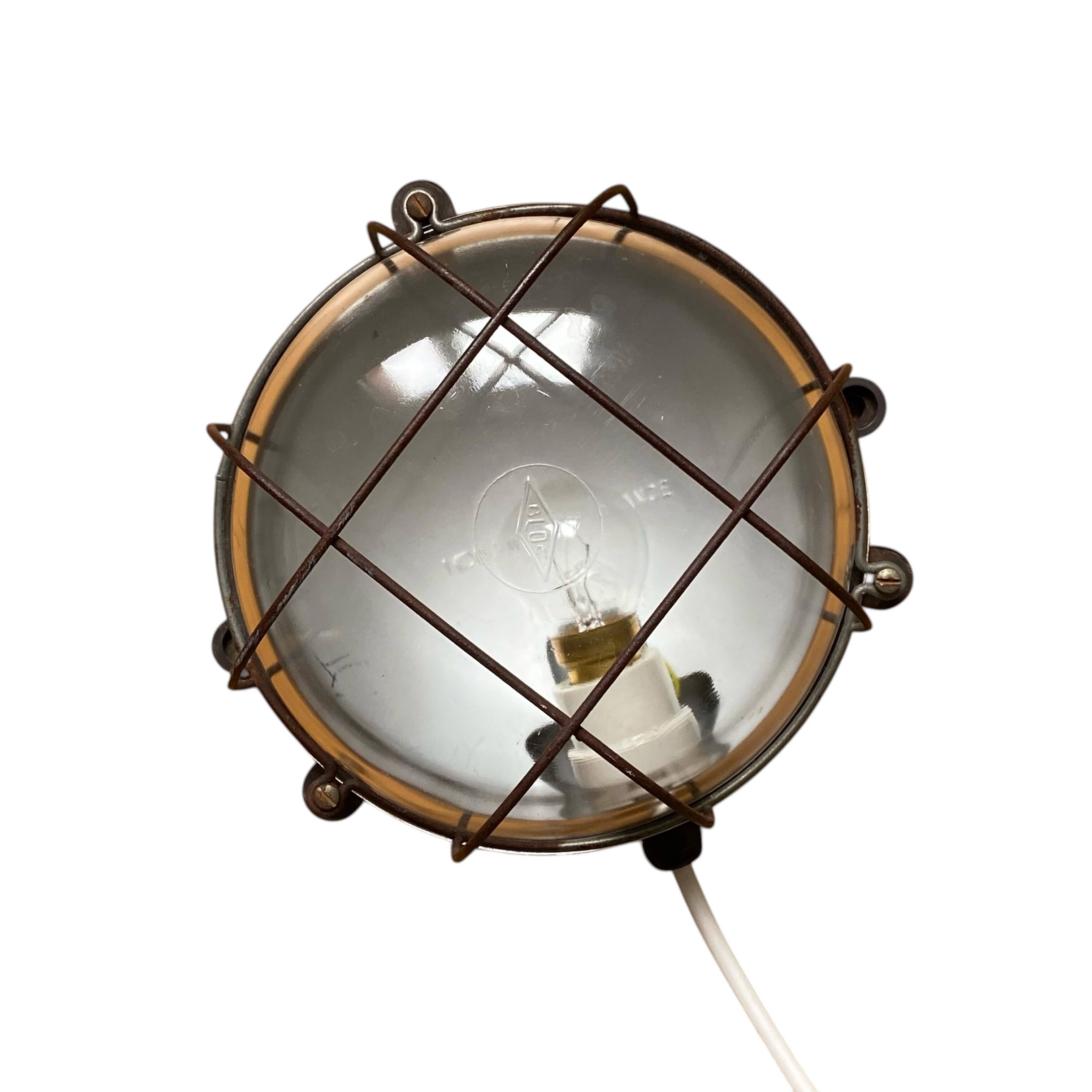 Waterproof industrial porthole light in Bakelite with a glass globe.