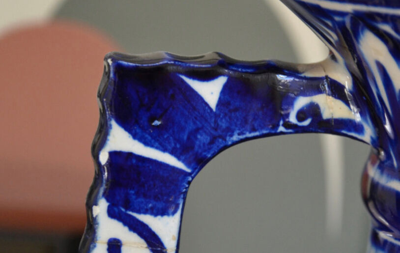 White hand-painted ceramic vase with blue patterns